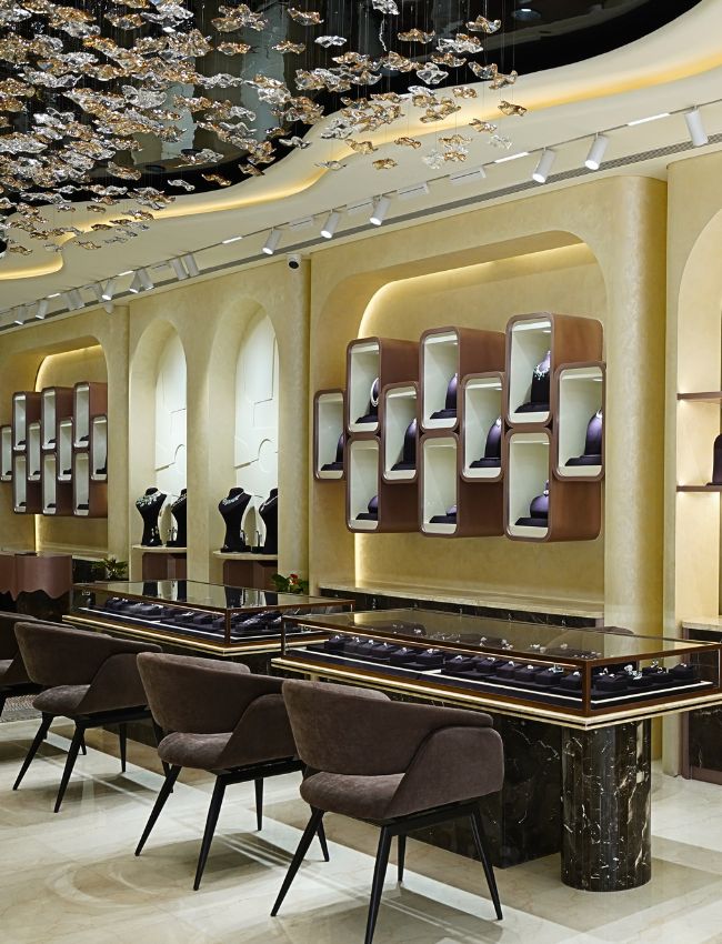 Luxury lab grown diamond jewellery store interior with display cases and elegant seating.
