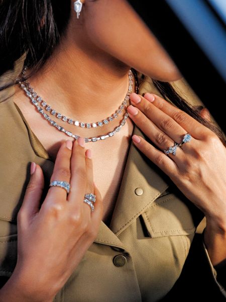 Woman wearing lab grown diamond tennis necklaces and rings