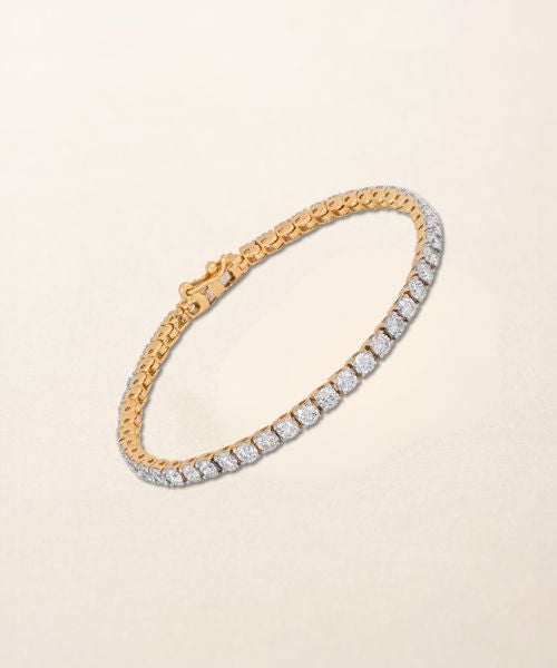 Lab grown diamond tennis bracelet in yellow gold on a neutral background